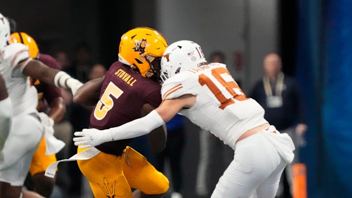 Arizona State wide receiver Melquan Stovall is tackled by Texas defensive back Michael Taaffe.
