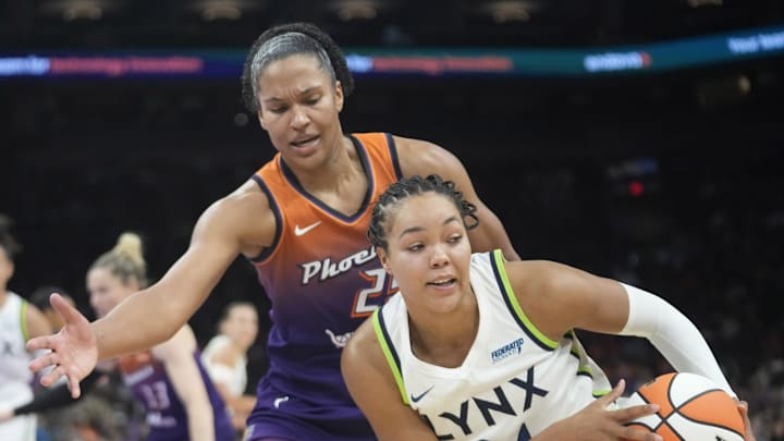 Phoenix Mercury forward Alyssa Thomas (25) defends against Minnesota Lynx forward Napheesa Collier (24) during the third quarter at PHX Arena on July 9, 2025.