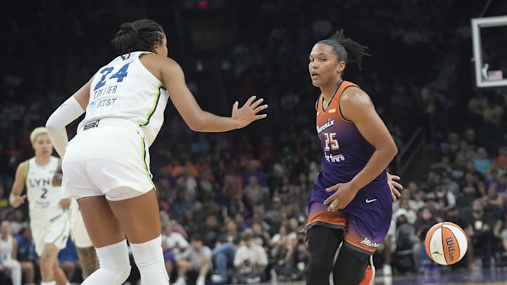 Phoenix Mercury forward Alyssa Thomas (25) passes the ball behind her back while defended by Minnesota Lynx forward Napheesa Collier (24) during the first quarter at PHX Arena on July 9, 2025.