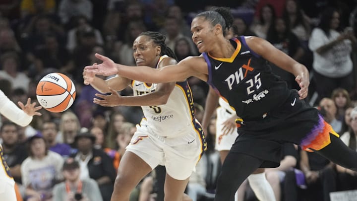 Indiana Fever guard Kelsey Mitchell (0) and Phoenix Mercury forward Alyssa Thomas (25) battle for a loose ball during the third quarter at PHX Arena on Sept. 2, 2025.