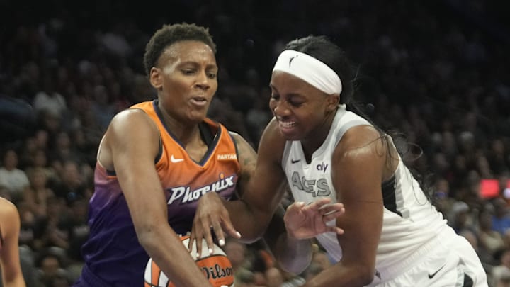 Phoenix Mercury forward Natasha Mack (4) strips the ball away from Las Vegas Aces guard Jackie Young (0) during the second quarter at Footprint Center on Sept. 1, 2024, in Phoenix.