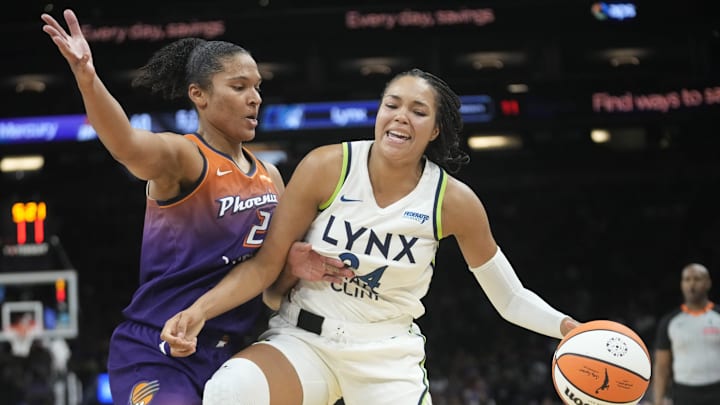 Phoenix Mercury forward Alyssa Thomas (25) defends against Minnesota Lynx forward Napheesa Collier (24) during the fourth quarter at PHX Arena on July 9, 2025.