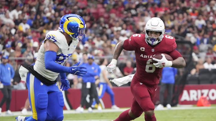 Arizona Cardinals running back James Conner (6) is pursued by Los Angeles Rams linebacker Michael Hoecht (97) during the first quarter at State Farm Stadium.