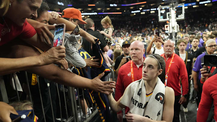 Jun 30, 2024; Phoenix, Ariz., U.S.; Indiana Fever guard Caitlin Clark (22) signs autographs for fans after beating the Phoenix Mercury 88-82 at Footprint Center. Mandatory Credit: Michael Chow-Arizona Republic Jun 30, 2024; Phoenix, Ariz., U.S.; Indiana Fever guard Caitlin Clark (22) signs autographs for fans after beating the Phoenix Mercury 88-82 at Footprint Center. Mandatory Credit: Michael Chow-Arizona Republic