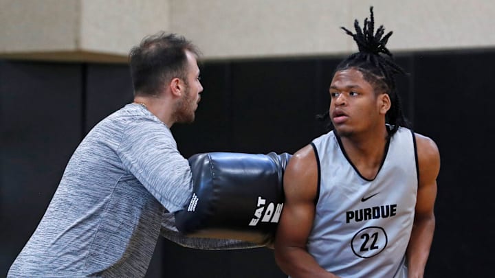 Purdue director of player development Sasha Stefanovic defends Gicarri Harris during practice, 