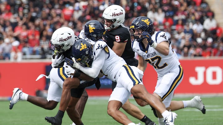 Nov 1, 2025; Houston, Texas, USA; Houston Cougars running back DJ Butler (25) is knocked out of bounds by West Virginia Mountaineers safety Israel Boyce (7) in the first half at TDECU Stadium. Mandatory Credit: Thomas Shea-Imagn Images Nov 1, 2025; Houston, Texas, USA; Houston Cougars running back DJ Butler (25) is knocked out of bounds by West Virginia Mountaineers safety Israel Boyce (7) in the first half at TDECU Stadium. Mandatory Credit: Thomas Shea-Imagn Images
