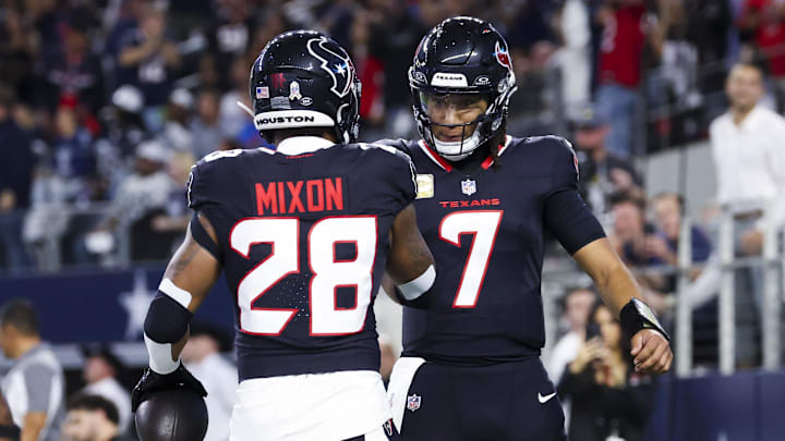 Nov 18, 2024; Arlington, Texas, USA;  Houston Texans running back Joe Mixon (28) celebrates with Houston Texans quarterback C.J. Stroud (7) after scoring a touchdown  during the first quarter against the Dallas Cowboys at AT&T Stadium. Mandatory Credit: Kevin Jairaj-Imagn Images