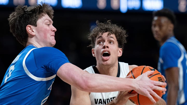 Kentucky Wildcats forward Trent Noah (9) pressures Vanderbilt Commodores guard Chris Manon (30) on his shot during their game at Memorial Gym in Nashville, Tenn., Saturday, Jan. 25, 2025.