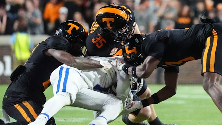 Kentucky running back Jamarion Wilcox (10) is taken down by Tennessee defensive backs Andre Turrentine (2), Will Brooks (35), and Jermod McCoy (3) during NCAA college football game between Tennessee and Kentucky on Saturday, Nov. 2, 2024, in Knoxville, Tenn.