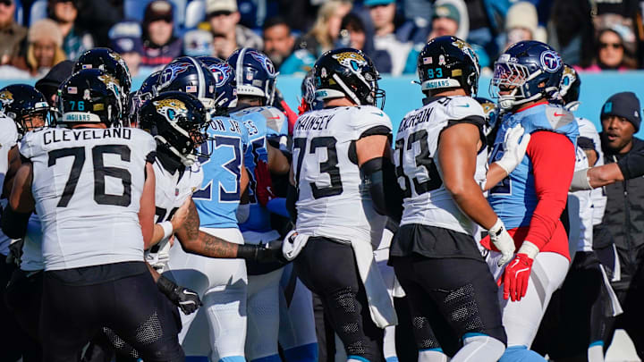 There’s a scuffle on the sidelines after a late hit on Jacksonville Jaguars quarterback Trevor Lawrence (16) by Tennessee Titans linebacker Arden Key (49) during the second quarter at Nissan Stadium in Nashville, Tenn., Sunday, Nov. 30, 2025.