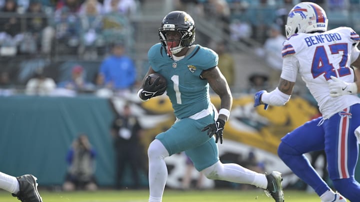 Jan 11, 2026; Jacksonville, FL, USA; Jacksonville Jaguars running back Travis Etienne Jr. (1) runs with the ball during the second half against the Buffalo Bills in an AFC Wild Card Round game at EverBank Stadium. Mandatory Credit: Melina Myers-Imagn Images
