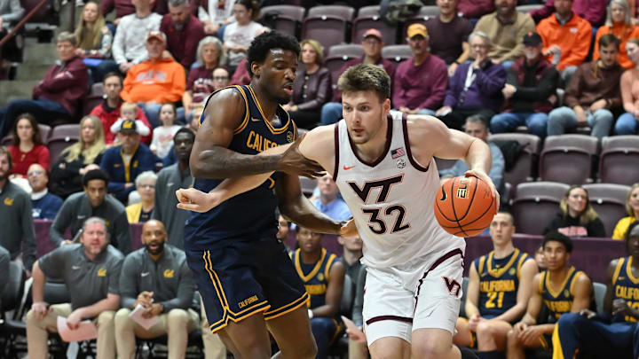 Jan 10, 2026; Blacksburg, Va.; Virginia Tech center Christian Gurdak (32) drives the baseline defended by California forward Lee Dort (34)  during the first half.
