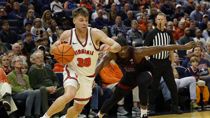 Jan 10, 2026; Charlottesville, Virginia, USA; Virginia Cavaliers guard Dallin Hall (30) drives to the basket past Stanford Cardinal forward Chisom Okpara (10) in the second half at John Paul Jones Arena. Mandatory Credit: Geoff Burke-Imagn Images