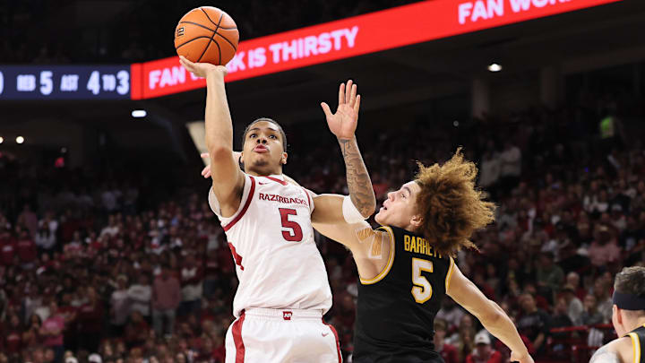 Feb 21, 2026; Fayetteville, Arkansas, USA; Arkansas Razorbacks guard Darius Acuff Jr (5) shoots during the first half as Missouri Tigers guard T.O. Barrett (5) defends at Bud Walton Arena. Mandatory Credit: Nelson Chenault-Imagn Images
