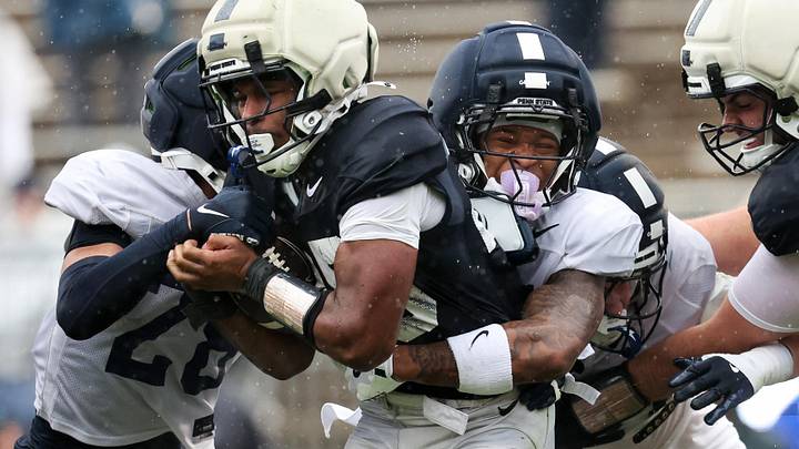 Apr 25, 2026; University Park, PA, USA; Penn State Nittany Lions safety Omarion Davis (27) attempts to tackle running back Quinton Martin Jr. (25) during the Penn State Blue-White Spring game at Beaver Stadium. Mandatory Credit: Matthew O'Haren-Imagn Images