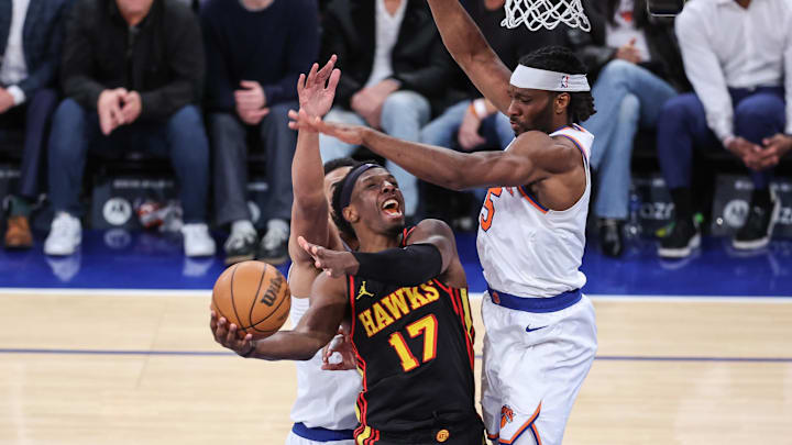 Feb 12, 2025; New York, New York, USA;  Atlanta Hawks forward Onyeka Okongwu (17) looks to drive past New York Knicks forward Precious Achiuwa (5) in overtime at Madison Square Garden. Mandatory Credit: Wendell Cruz-Imagn Images