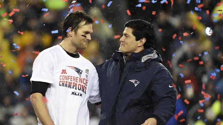 Jan 18, 2015; Foxborough, MA, USA; New England Patriots quarterback Tom Brady (left) is congratulated by former Patriots linebacker Tedy Bruschi (right) after the AFC Championship Game against the Indianapolis Colts at Gillette Stadium. Mandatory Credit: Robert Deutsch-Imagn Images