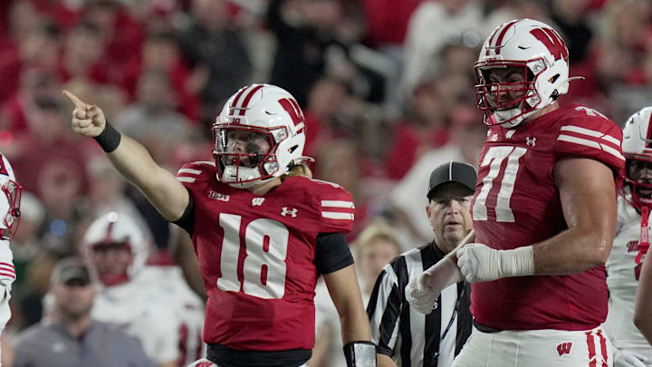 Wisconsin quarterback Danny O'Neil (18) signals first down during the second quarter of their game against Miami (Ohio) Thursday, August 28, 2025 at Camp Randall Stadium in Madison, Wisconsin.