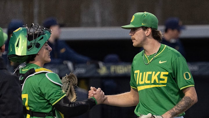 Oregon catcher Anson Aroz, left, congratulates pitcher Seth Mattox after the Ducks defeated the Toledo Rockets at PK Park in their home opener.