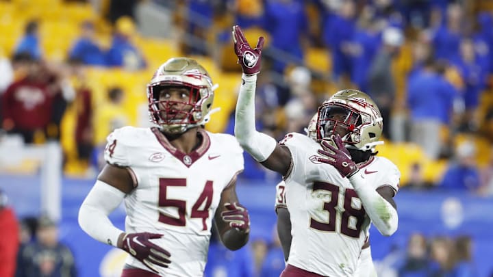 Nov 4, 2023; Pittsburgh, Pennsylvania, USA;  Florida State Seminoles defensive back Shyheim Brown (38) celebrates his fumble recovery alongside defensive lineman Byron Turner Jr. (54) against the Pittsburgh Panthers during the fourth quarter at Acrisure Stadium. The Seminoles won 24-7. Mandatory Credit: Charles LeClaire-USA TODAY Sports