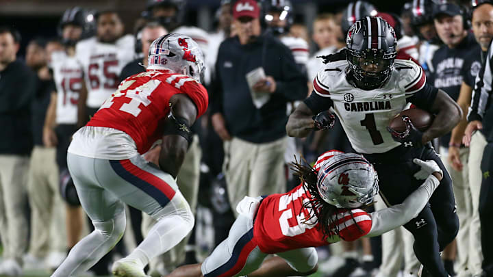 Nov 1, 2025; Oxford, Mississippi, USA; South Carolina Gamecocks running back Rahsul Faison (1) runs the ball as Mississippi Rebels defensive back Cedrick Beavers (13) attempts to make the tackle during the second quarter at Vaught-Hemingway Stadium. Mandatory Credit: Petre Thomas-Imagn Images