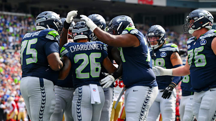 Sep 7, 2025; Seattle, Washington, USA; Seattle Seahawks running back Zach Charbonnet (26) celebrates with teammates after scoring a touchdown during the first half against San Francisco 49ers at Lumen Field. Sep 7, 2025; Seattle, Washington, USA; Seattle Seahawks running back Zach Charbonnet (26) celebrates with teammates after scoring a touchdown during the first half against San Francisco 49ers at Lumen Field.