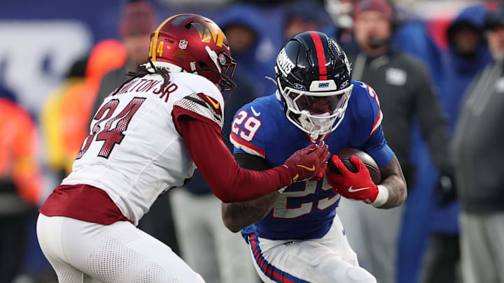 Dec 14, 2025; East Rutherford, New Jersey, USA; New York Giants running back Tyrone Tracy Jr. (29) runs the ball against Washington Commanders cornerback Antonio Hamilton Sr. (34) during the fourth quarter at MetLife Stadium. Dec 14, 2025; East Rutherford, New Jersey, USA; New York Giants running back Tyrone Tracy Jr. (29) runs the ball against Washington Commanders cornerback Antonio Hamilton Sr. (34) during the fourth quarter at MetLife Stadium.