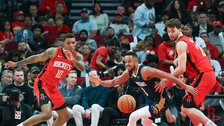 Dec 19, 2024; Houston, Texas, USA;  New Orleans Pelicans guard CJ McCollum (3) looses the ball to Houston Rockets center Alperen Sengun (28) in the second half at Toyota Center. Mandatory Credit: Thomas Shea-Imagn Images