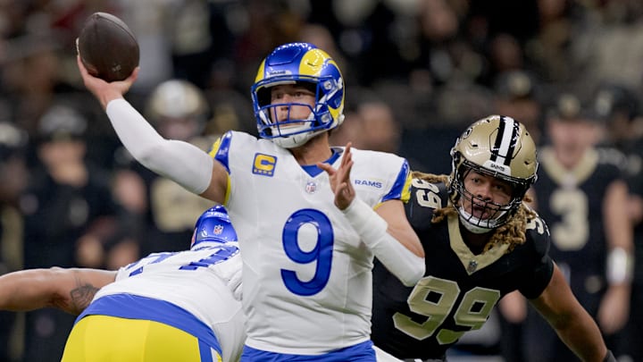 Dec 1, 2024; New Orleans, Louisiana, USA; Los Angeles Rams quarterback Matthew Stafford (9) throws against New Orleans Saints defensive end Chase Young (99) during the first half at Caesars Superdome. Mandatory Credit: Matthew Hinton-Imagn Images