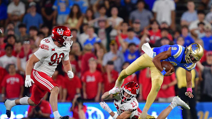Aug 30, 2025; Pasadena, California, USA; Utah Utes defensive end John Henry Daley (90) and safety Jackson Bennee (23) move in against UCLA Bruins quarterback Nico Iamaleava (9) during the first half at Rose Bowl. Mandatory Credit: Gary A. Vasquez-Imagn Images