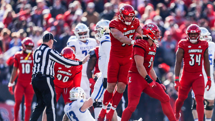 Louisville Cardinals defensive lineman Mason Reiger (95) celebrates with Louisville Cardinals defensive lineman Ashton Gillotte (9) after Gillotte sacked Kentucky Wildcats quarterback Devin Leary (13) for a loss in the first half Saturday. Nov. 25, 2023.