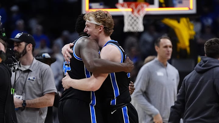 Mar 22, 2025; Denver, CO, USA; Brigham Young Cougars center Fousseyni Traore (45) and forward Richie Saunders (15)  react after defeating the Wisconsin Badgers in the second round of the NCAA Tournament  at Ball Arena. Mandatory Credit: Ron Chenoy-Imagn Images