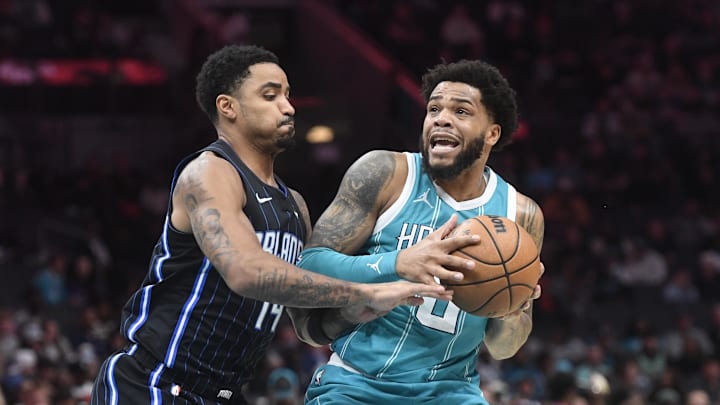 Mar 25, 2025; Charlotte, North Carolina, USA; Charlotte Hornets forward Miles Bridges (0) looks to pass as he is defended by Orlando Magic guard Gary Harris (14) during the second half at the Spectrum Center. Mandatory Credit: Sam Sharpe-Imagn Images Mar 25, 2025; Charlotte, North Carolina, USA; Charlotte Hornets forward Miles Bridges (0) looks to pass as he is defended by Orlando Magic guard Gary Harris (14) during the second half at the Spectrum Center. Mandatory Credit: Sam Sharpe-Imagn Images