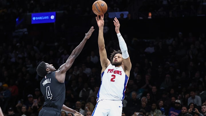 Nov 7, 2025; Brooklyn, New York, USA;  Detroit Pistons guard Cade Cunningham (2) takes a three point shot past Brooklyn Nets guard Drake Powell (4) in the second quarter at Barclays Center. Mandatory Credit: Wendell Cruz-Imagn Images