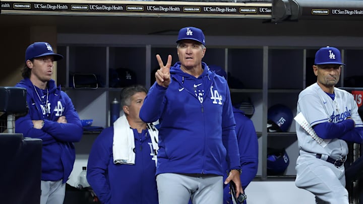 Los Angeles Dodgers bench coach and acting manager for the game Danny Lehmann (left) and Bob Geren (center) watch the game from the dugout in the ninth inning against the San Diego Padres at Petco Park on May 6, 2023.