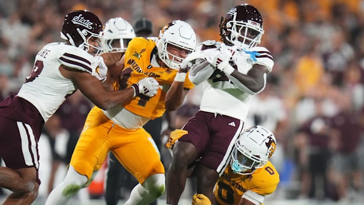 Arizona State defensive back Cole Martin (0) and linebacker Keyshaun Elliott (44) tackle Mississippi State Bulldogs running back Davon Booth (21) at Mountain America Stadium on Sept. 7, 2024, in Tempe.