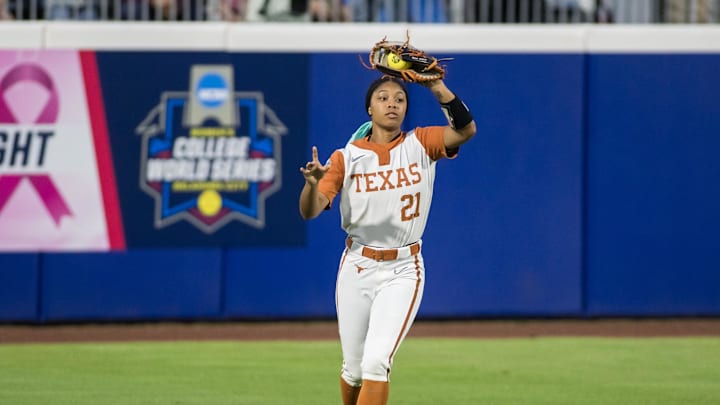 Jun 4, 2025; Oklahoma City, OK, USA;  Texas Longhorns outfielder Kayden Henry (21) catches the ball for an out in the sixth inning against the Texas Tech Red Raiders during game one of the NCAA Softball Women's College World Series finals at Devon Park. Mandatory Credit: Brett Rojo-Imagn Images