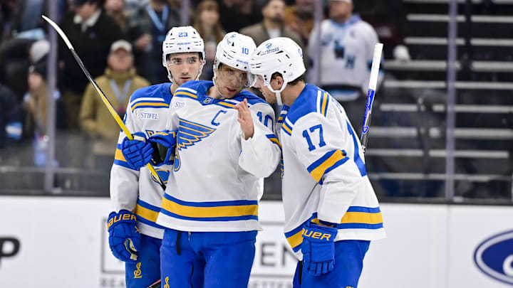 Jan 9, 2026; Salt Lake City, Utah, USA; St. Louis Blues center Brayden Schenn (10) discuss strategy with St. Louis Blues defenseman Cam Fowler (17) during third period against the Utah Mammoth at Delta Center. Mandatory Credit: Peter Creveling-Imagn Images