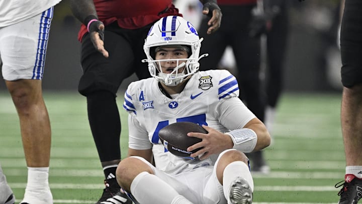 Dec 6, 2025; Arlington, TX, USA; BYU Cougars quarterback Bear Bachmeier (47) sits on the field after recovering the loose ball during the first half against the Texas Tech Red Raiders at AT&T Stadium. Mandatory Credit: Jerome Miron-Imagn Images