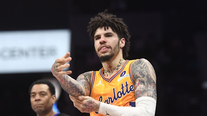 Dec 18, 2025; Charlotte, North Carolina, USA;  Charlotte Hornets guard LaMelo Ball (1) rubs his elbow after falling during the second half against the Atlanta Hawks at the Spectrum Center. Mandatory Credit: Sam Sharpe-Imagn Images