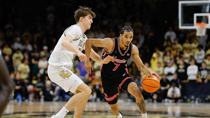 Feb 8, 2025; Boulder, Colorado, USA; Houston Cougars guard Milos Uzan (7) controls the ball under pressure from Colorado Buffaloes forward Sebastian Rancik (7) in the first half at CU Events Center. Mandatory Credit: Isaiah J. Downing-Imagn Images