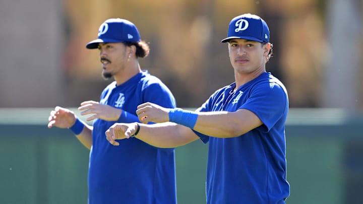 Dodgers second baseman Miguel Vargas (14) and catcher Diego Cartaya (76) stretch during spring training at Camelback Ranch on Feb. 19, 2024.