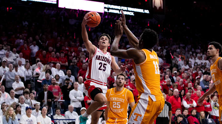 Dec 17, 2022; Tucson, Arizona, USA; Arizona Wildcats guard Kerr Kriisa (25) drives to the the basket against Tennessee Volunteers forward Tobe Awaka (11) and guard Santiago Vescovi (25) during the second half at McKale Center. Dec 17, 2022; Tucson, Arizona, USA; Arizona Wildcats guard Kerr Kriisa (25) drives to the the basket against Tennessee Volunteers forward Tobe Awaka (11) and guard Santiago Vescovi (25) during the second half at McKale Center.