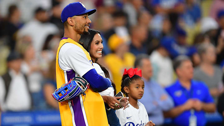 Los Angeles Dodgers right fielder Mookie Betts (50) and Vanessa Bryant watch as Natalia Bryant throws out the ceremonial first pitch at Dodger Stadium. Los Angeles Dodgers right fielder Mookie Betts (50) and Vanessa Bryant watch as Natalia Bryant throws out the ceremonial first pitch at Dodger Stadium.
