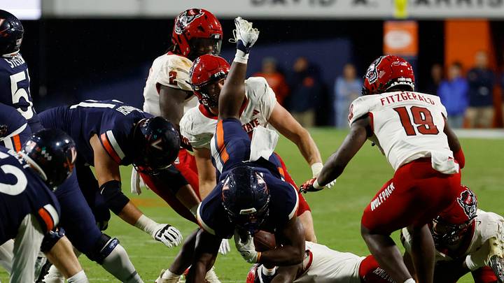 Sep 22, 2023; Charlottesville, Virginia, USA; Virginia Cavaliers running back Mike Hollins (7) is tackled by North Carolina State Wolfpack safety Sean Brown (0) during the third quarter at Scott Stadium. Mandatory Credit: Geoff Burke-USA TODAY Sports Sep 22, 2023; Charlottesville, Virginia, USA; Virginia Cavaliers running back Mike Hollins (7) is tackled by North Carolina State Wolfpack safety Sean Brown (0) during the third quarter at Scott Stadium. Mandatory Credit: Geoff Burke-USA TODAY Sports