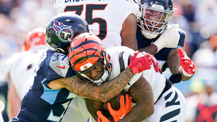 Tennessee Titans safety Amani Hooker (37) stops Cincinnati Bengals running back Joe Mixon (28)    during the fourth quarter at Nissan Stadium in Nashville, Tenn., Sunday, Oct. 1, 2023.