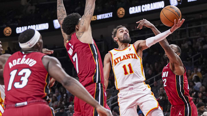 Feb 24, 2025; Atlanta, Georgia, USA; Atlanta Hawks guard Trae Young (11) shoots behind Miami Heat forward Andrew Wiggins (22) during the second half at State Farm Arena. Mandatory Credit: Dale Zanine-Imagn Images