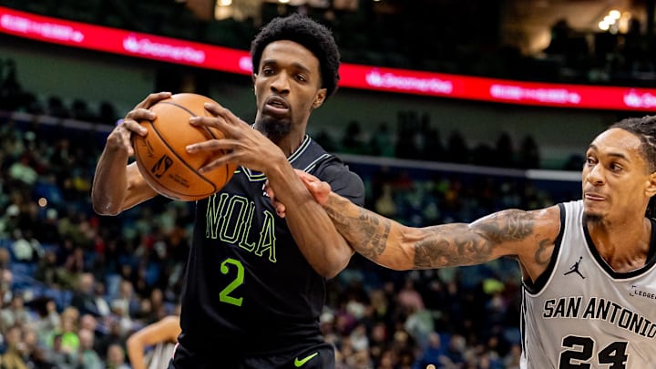 Dec 8, 2025; New Orleans, Louisiana, USA;  San Antonio Spurs guard/forward Devin Vassell (24) fouls New Orleans Pelicans forward Herbert Jones (2) during the first half at Smoothie King Center. Mandatory Credit: Stephen Lew-Imagn Images