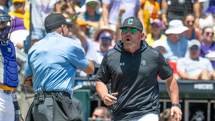 Jun 22, 2025; Omaha, Neb, USA;  Coastal Carolina Chanticleers head coach Kevin Schnall (9) gets thrown out of the game arguing with the umpires during the game against the LSU Tigers during the first inning at Charles Schwab Field. Mandatory Credit: Steven Branscombe-Imagn Images