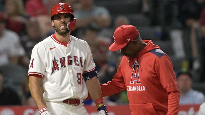 Jun 9, 2025; Anaheim, California, USA;  Los Angeles Angels manager Ron Washington (37) checks on center fielder Chris Taylor (33) after he was hit by a pitch left hand in the eighth inning against the Athletics at Angel Stadium. Taylor was diagnosed with a fracture in the hand. Mandatory Credit: Jayne Kamin-Oncea-Imagn Images